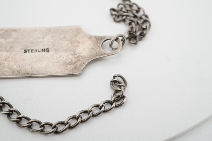 A silver military bracelet stamped sterling, and engraved ‘43450 G.W. Day, RAF C.ofE.’ X prisoner of war at Stalag prison. Condition - fair to good, one link requires rejoining.